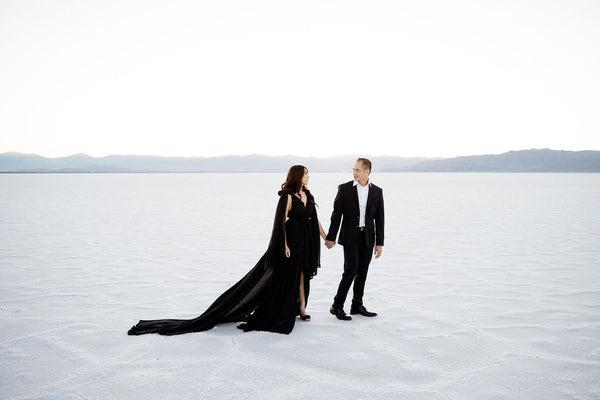 couple photos at the salt flats in a black dress and suit