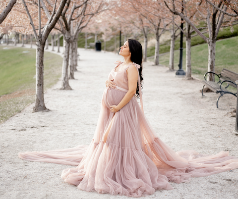Maternity photo with cherry blossom trees