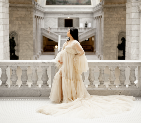 maternity photos in beige long dress inside the capitol building