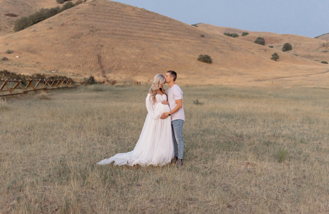 maternity photos, couple in field holding the baby bump
