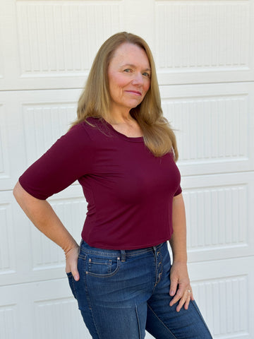 image of a person wearing a berry top