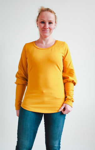 image of person wearing  yellow top