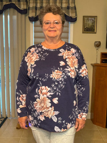 image of a woman wearing a floral sweatshirt