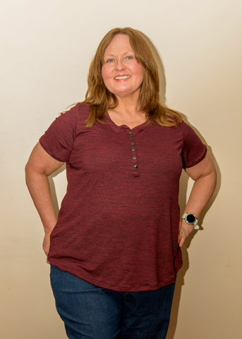 image of a person wearing a maroon top