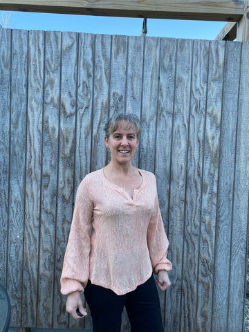 image of person wearing blush top