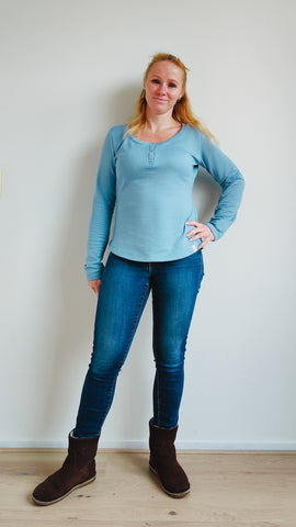 image of a person wearing a light blue henley top