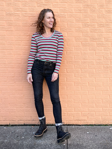 image of a person wearing a striped top and black pants