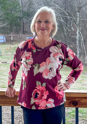 image of woman wearing pink floral top