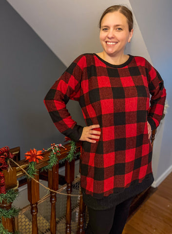 image of a woman wearing a black a red plaid dress
