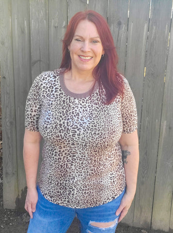 image of a person wearing an animal print top