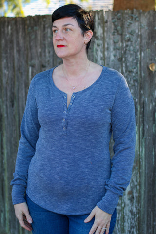 image of woman wearing a long sleeve blue henley top