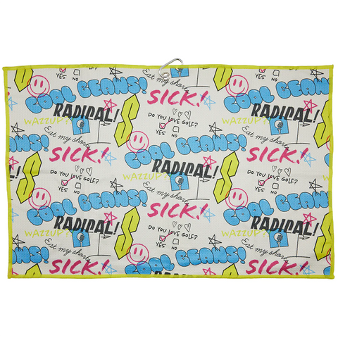 Image of golf towel, which is white and yellow, with text and smileys. With a neutral background.