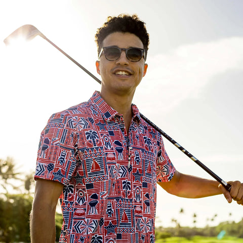 Man on golf course looking happy, wearing American inspired golf tee