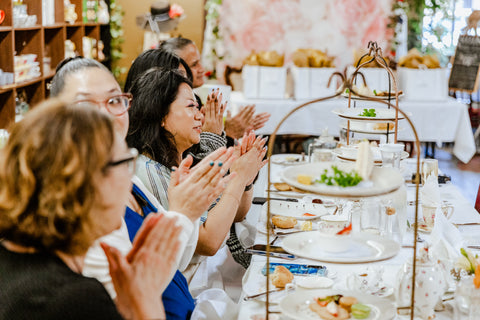 women clapping at the tea time