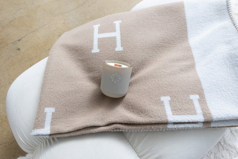 cozy candle in a blanket