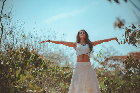 girl arms spread outside in nature