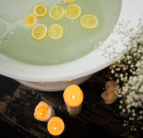 Bath with Lemons in Water and Candles