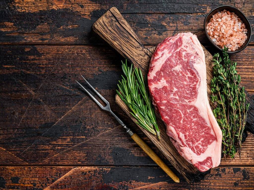 a new york strip steak on a cutting board