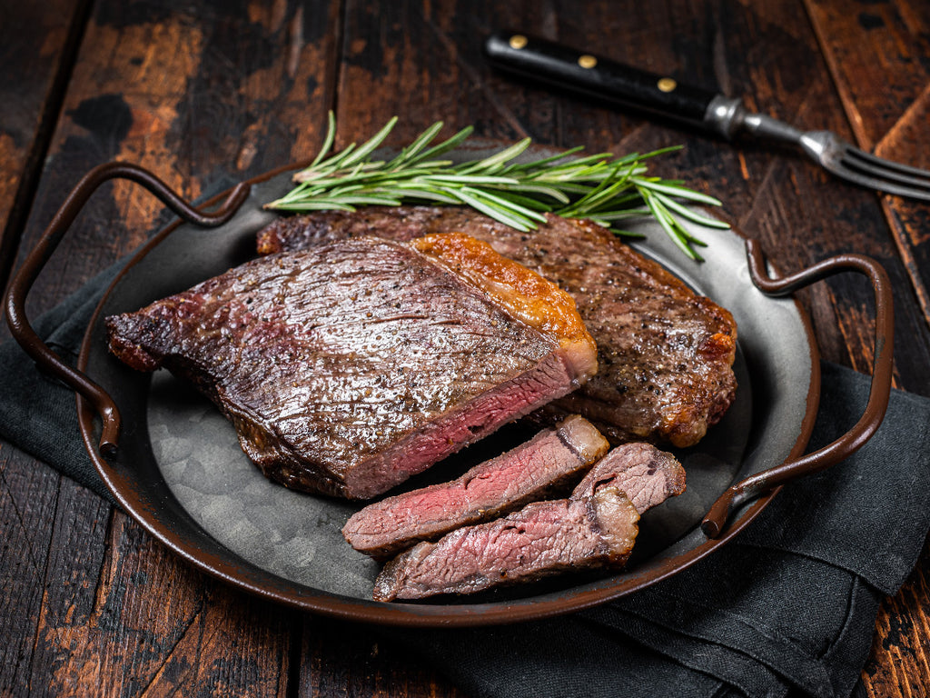 A sirloin steak on a grill