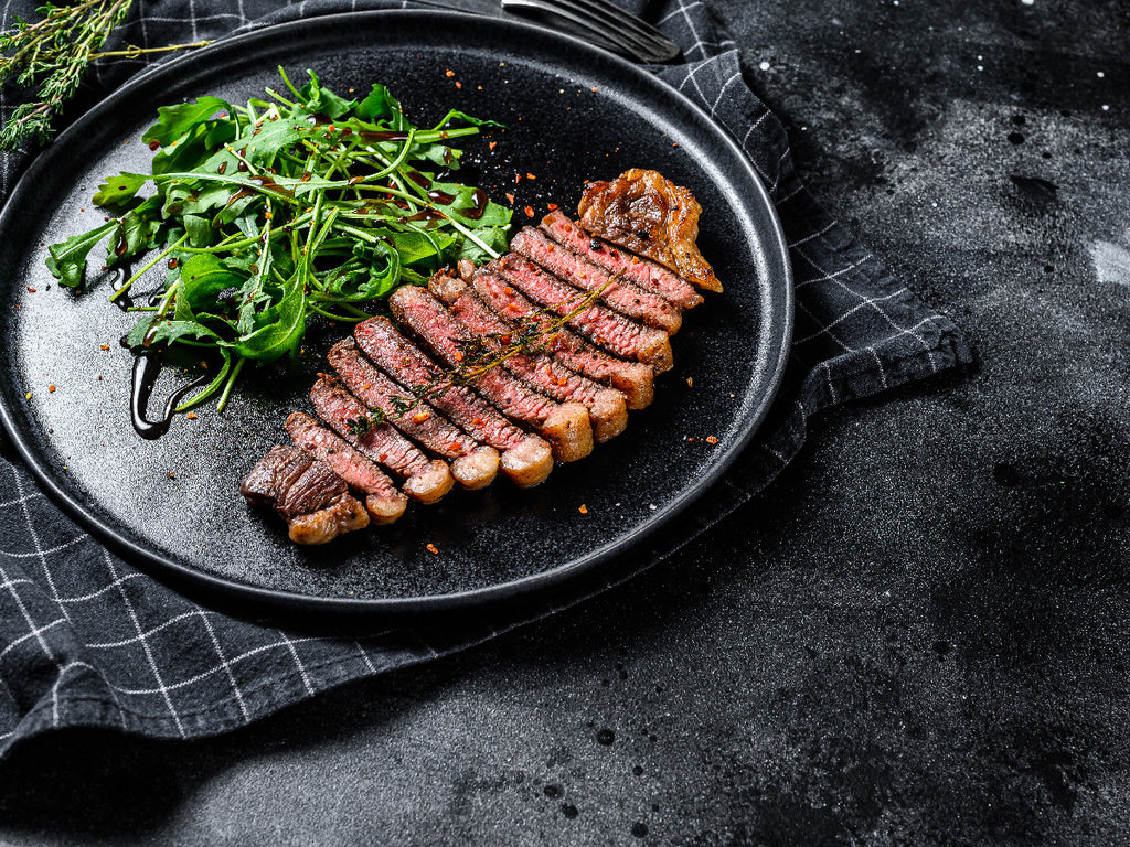 A sirloin steak resting on a plate