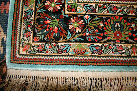 Close up of the corner of a silk handmade rug