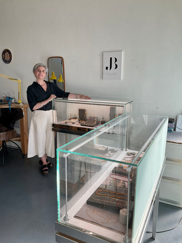 Bea Jareno Jewellery, founder Bea Jareno standing by studio boutique cabinets displays