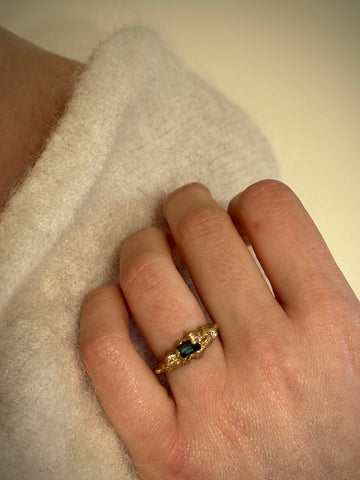 Bea Jareno Jewellery gold ring modelled in hand with a cream top and background