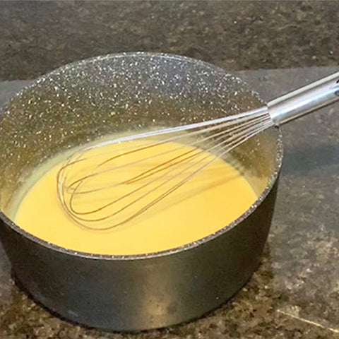 Add some condensed milk to the mixture and using a whisk mix it until thick and creamy.