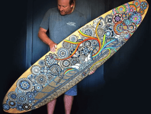 Artist Gareth W. Smith with a surfboard