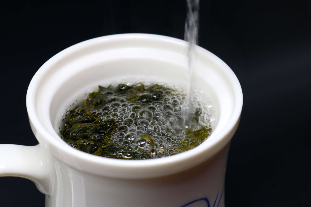 Tea steeping in the Jade Porcelain Tea Infuser Cup