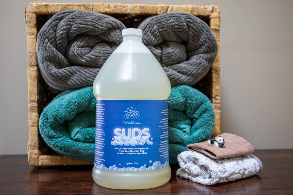 Bottle of SUDS with clean laundry