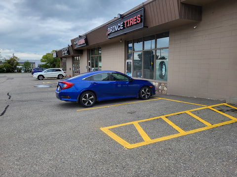 Blue car Infront of Prince Tires Store