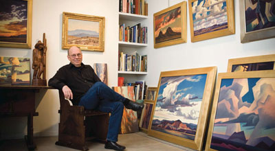 Mell seated in front of one of his most prized possessions, a 1927 Maynard Dixon painting titled Smoky Morning Virgin Valley Nevada.