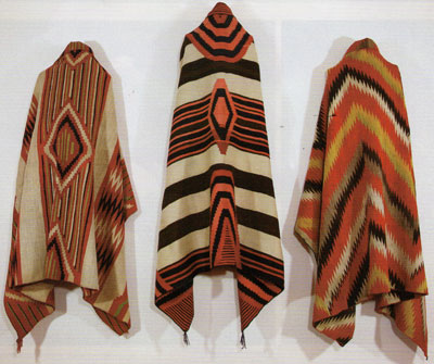 Left to Right: Navajo Classic Serape with all natural dyes, c. 1860, 73" x 52", Navajo Third Phase Chiefs Blanket with Ravelled Bayeta, Cochineal, Lac and Indigo dyes, c. 1870, 50" x 76.5", Navajo Transitional textile, c. 1880, 73" x 53"