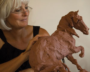 Jan Mapes fine-tunes her new sculpture, Hare Triggered