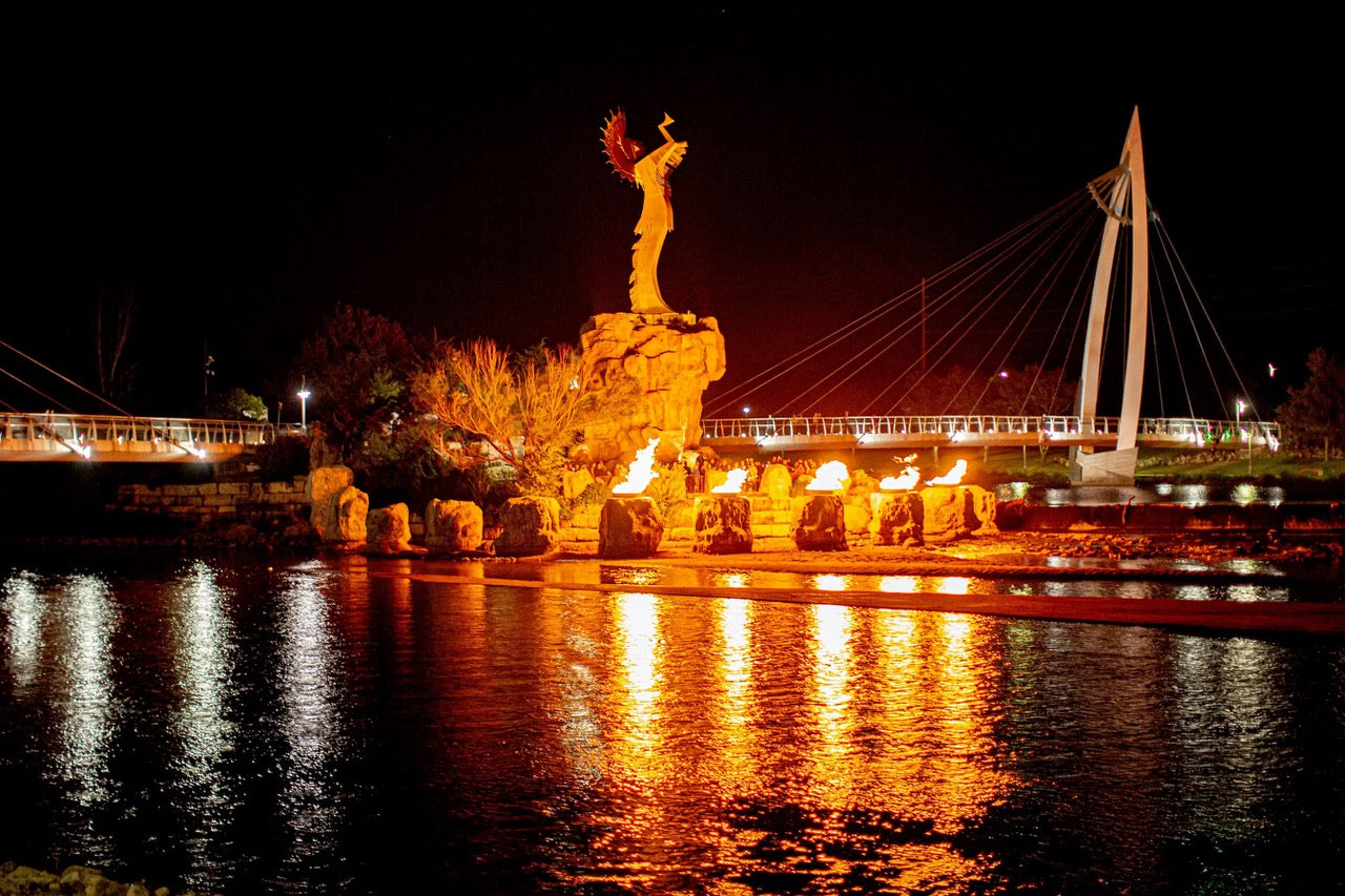 Keeper of the Plains sculpture surrounded by the Ring of Fire. Photo credit Trevor Hawkin and Visit Wichita.