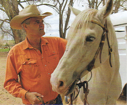 Billy Schenck, the artist saddles up his horse, Badger
