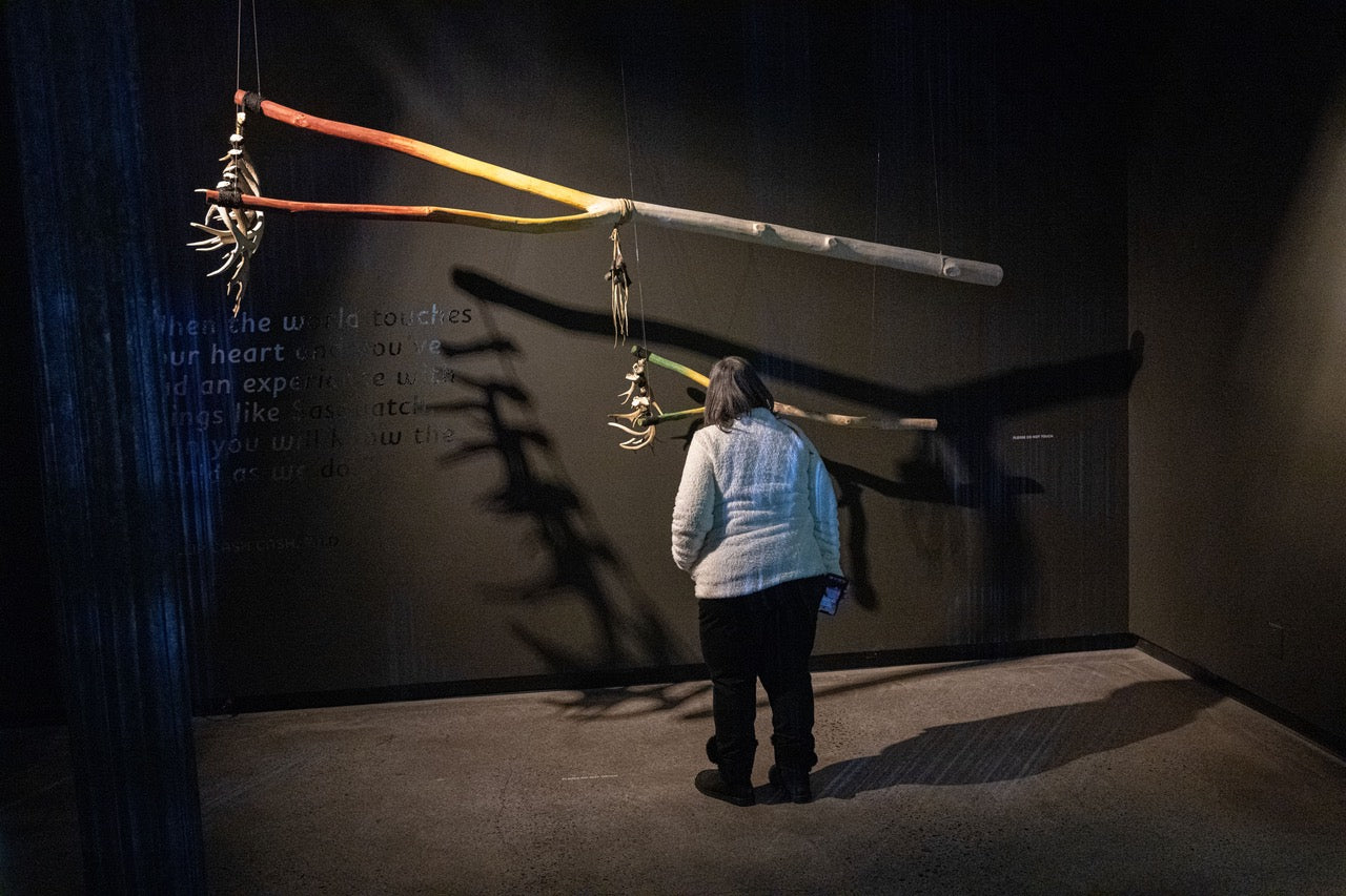 Visitor to 'Sensing Sasquatch' exhibition admiring Phillip Cash Cash, Nez Perce, Cayuse, 'Bigfoot Rattle.' Photo by Bill Jorgens.-1