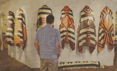 Michigan resident Anthony Hsu looks over some of the Navajo chief blankets that were made between 1850 and 1870. About 30 rare blankets are on display at the Mark Sublette Medicine Man Gallery in "Masterpieces of the Loom," a show that continues through May 20