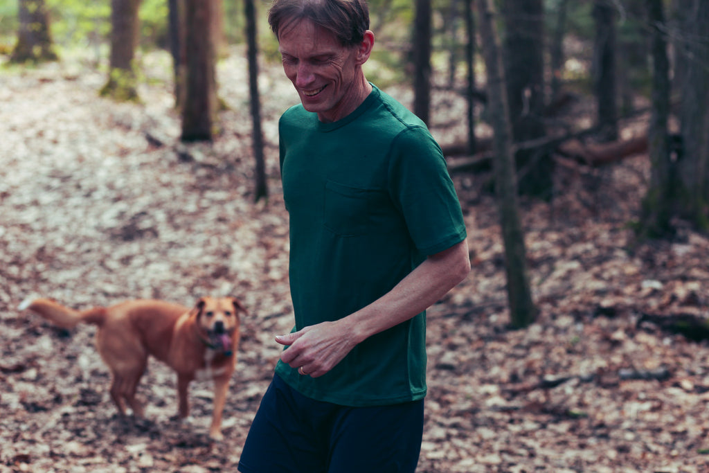 Scott Douglas running on a trail with his dog