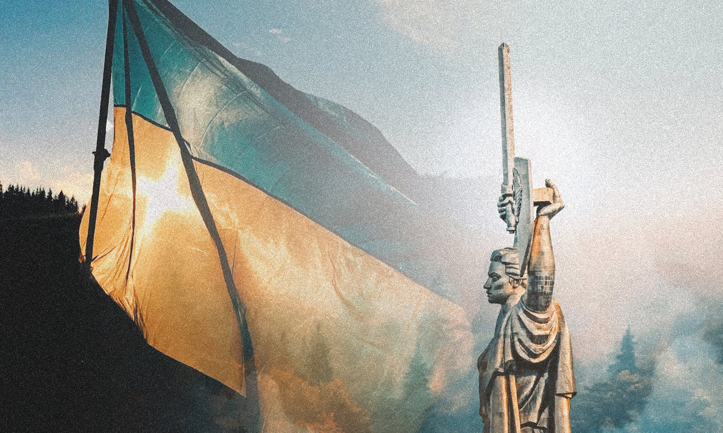 Mother Ukraine statue with Ukrainian flag