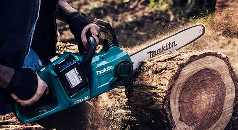 A makita chainsaw being used to cut a log