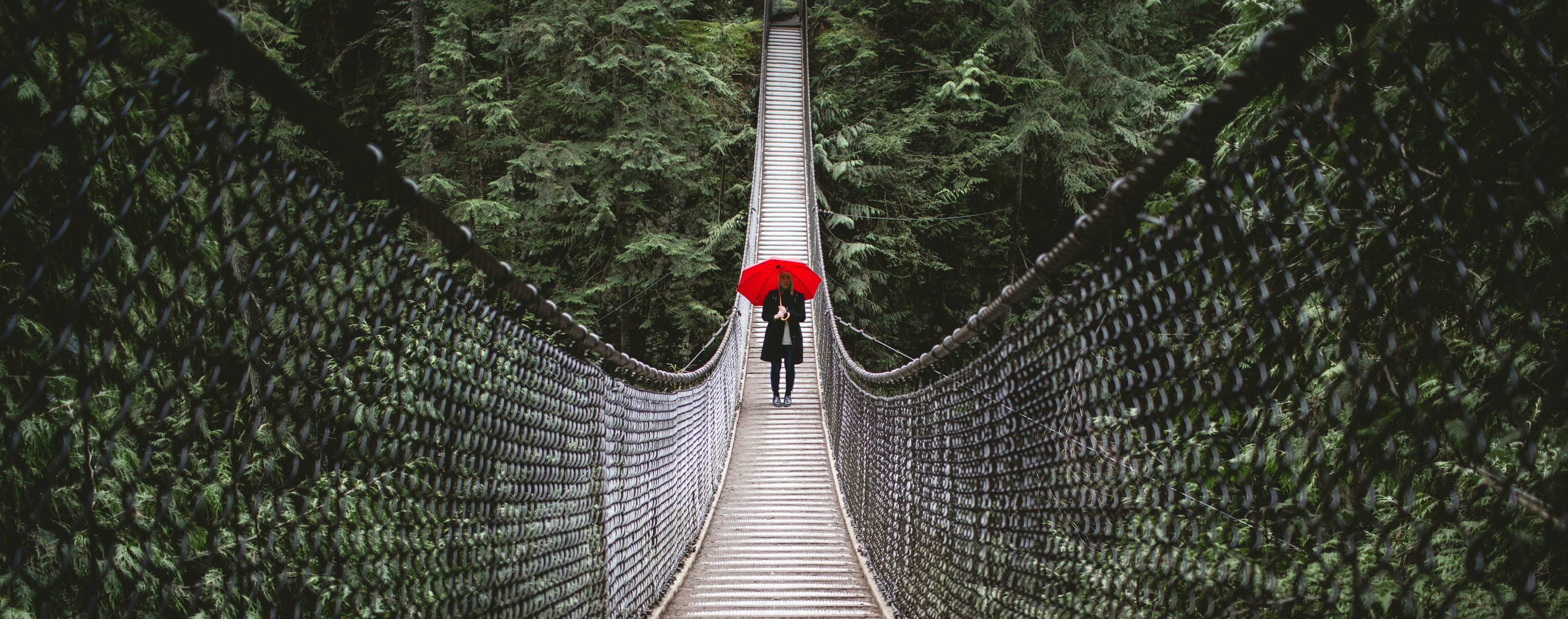 Red Merde Il Pleut Umbrella On a Bridge