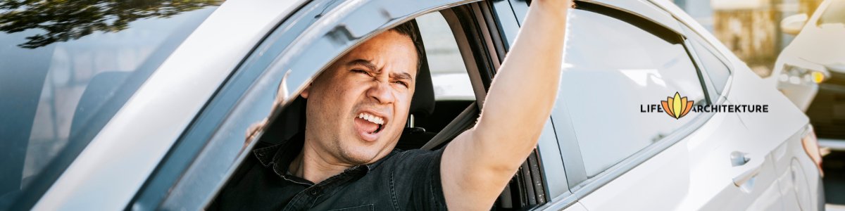 impatient man sitting in traffic and making aggressive signs through his car window