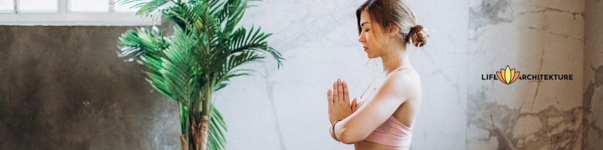 woman practicing mindfulness meditation with her hands joined together near heart