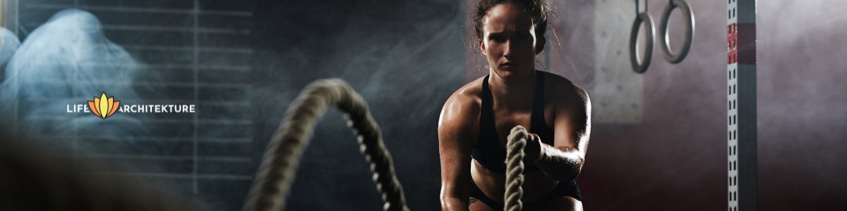woman doing cross fit with ropes pushing through discomfort