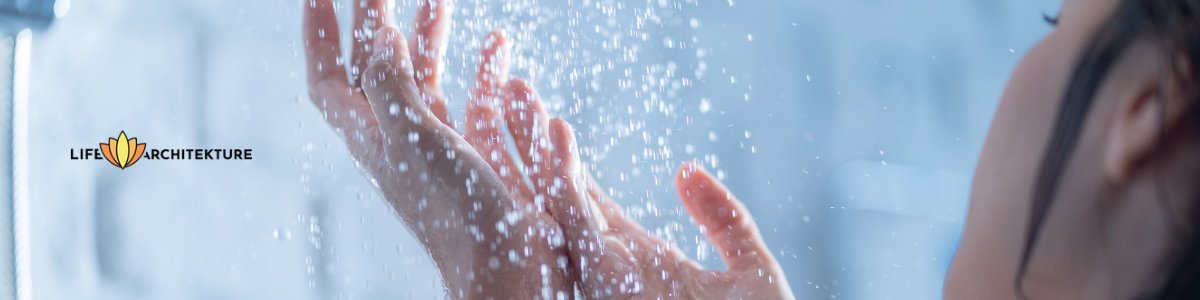 woman joining her hands under shower head with running water