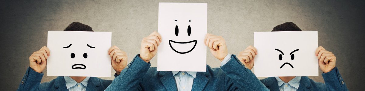 three man in a suite, covering their face with a smiley on paper representing happy, sad, angry smiley