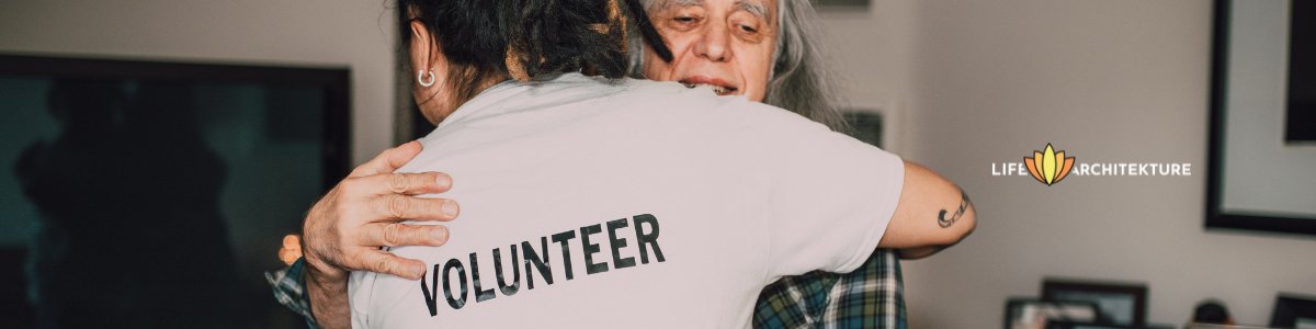 volunteer giving back by hugging an old woman