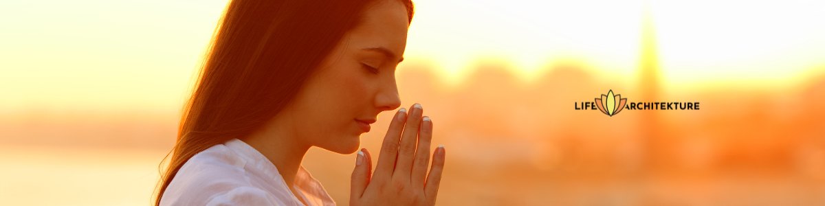 woman praying eyes closed grateful during sunset